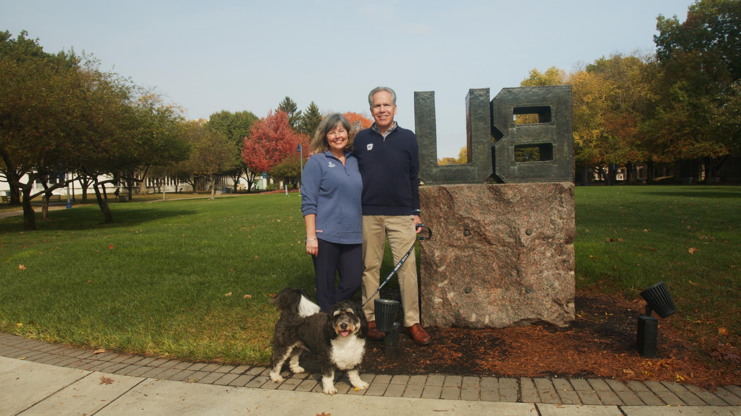 president danko and bethanie danko and black and white dog on a leash